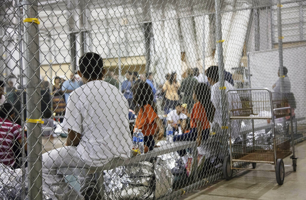 In this June 17, 2018, file photo provided by U.S. Customs and Border Protection, people who've been taken into custody related to cases of illegal entry into the United States, sit in one of the cages at a facility in McAllen, Texas. (U.S. Customs and Border Protection's Rio Grande Valley Sector via AP, File)