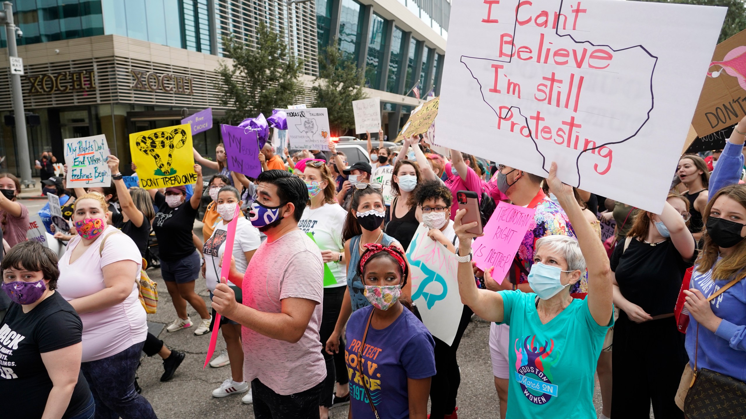 In this Oct. 2, 2021 file photo people participate in the Houston Women's March against Texas abortion ban walk from Discovery Green to City Hall in Houston. A federal appeals court is temporarily allowing the nation’s toughest abortion law to resume in Texas. The 5th U.S. Circuit Court of Appeals handed down the order Friday, Oct. 8. (Melissa Phillip/Houston Chronicle via AP)