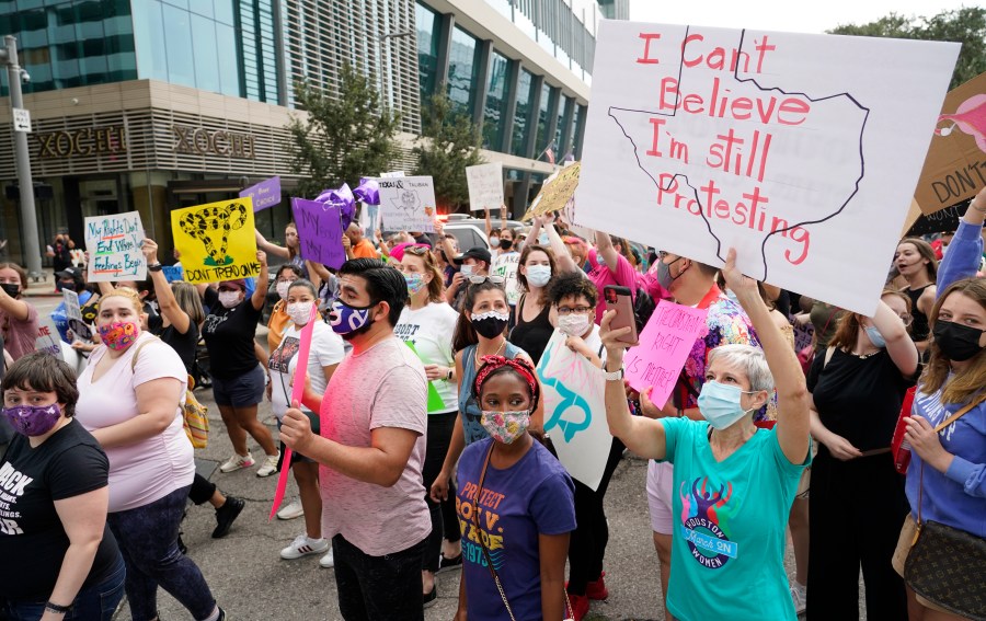 In this Oct. 2, 2021 file photo people participate in the Houston Women's March against Texas abortion ban walk from Discovery Green to City Hall in Houston. A federal appeals court is temporarily allowing the nation’s toughest abortion law to resume in Texas. The 5th U.S. Circuit Court of Appeals handed down the order Friday, Oct. 8. (Melissa Phillip/Houston Chronicle via AP)