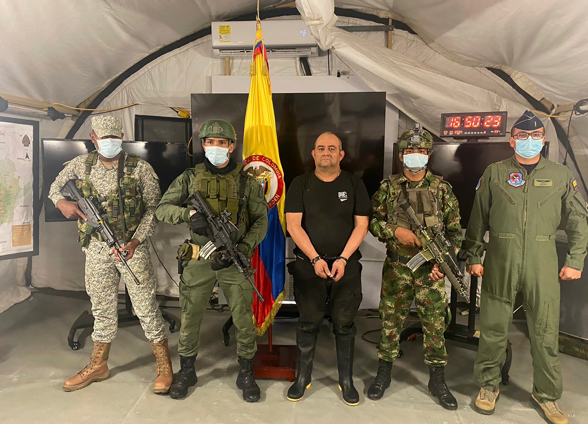 In this photo released by the Colombian presidential press office, one of the country’s most wanted drug traffickers, Dairo Antonio Usuga, alias “Otoniel,” leader of the violent Clan del Golfo cartel, is presented to the media at a military base in Necocli, Colombia, Saturday, Oct. 23, 2021. (Colombian presidential press office via AP)