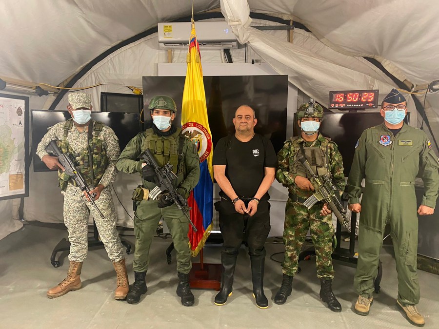 In this photo released by the Colombian presidential press office, one of the country’s most wanted drug traffickers, Dairo Antonio Usuga, alias “Otoniel,” leader of the violent Clan del Golfo cartel, is presented to the media at a military base in Necocli, Colombia, Saturday, Oct. 23, 2021. (Colombian presidential press office via AP)