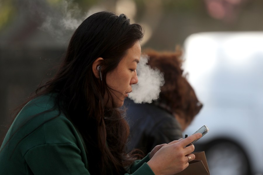 A pedestrian smokes an e-cigarette on Nov. 8, 2019, in San Francisco, California. (Justin Sullivan/Getty Images)