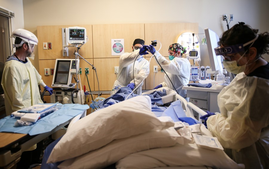 Clinicians perform a tracheostomy on a patient in a COVID-19 ICU in Mission Hills on Feb. 17, 2021 in Los Angeles. (Mario Tama/Getty Images)