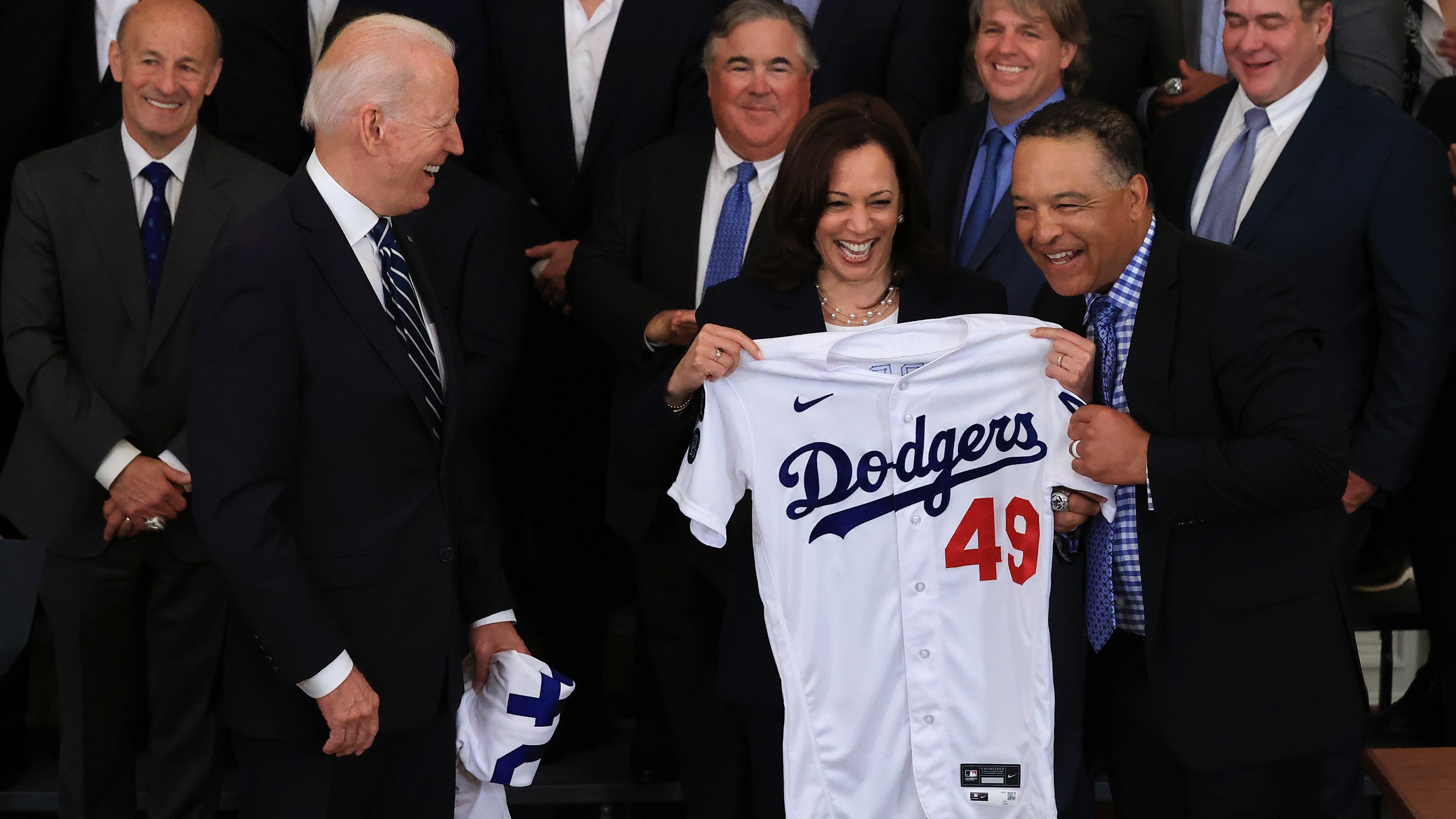 Vice President Kamala Harris, seen here being presented with a Dodgers jersey earlier this year during a team visit to the White House, will be rooting for the San Francisco Giants in the playoffs. (Chip Somodevilla / Getty Images)