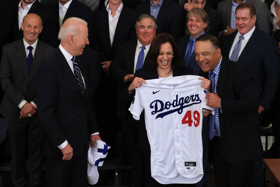 Vice President Kamala Harris, seen here being presented with a Dodgers jersey earlier this year during a team visit to the White House, will be rooting for the San Francisco Giants in the playoffs. (Chip Somodevilla / Getty Images)