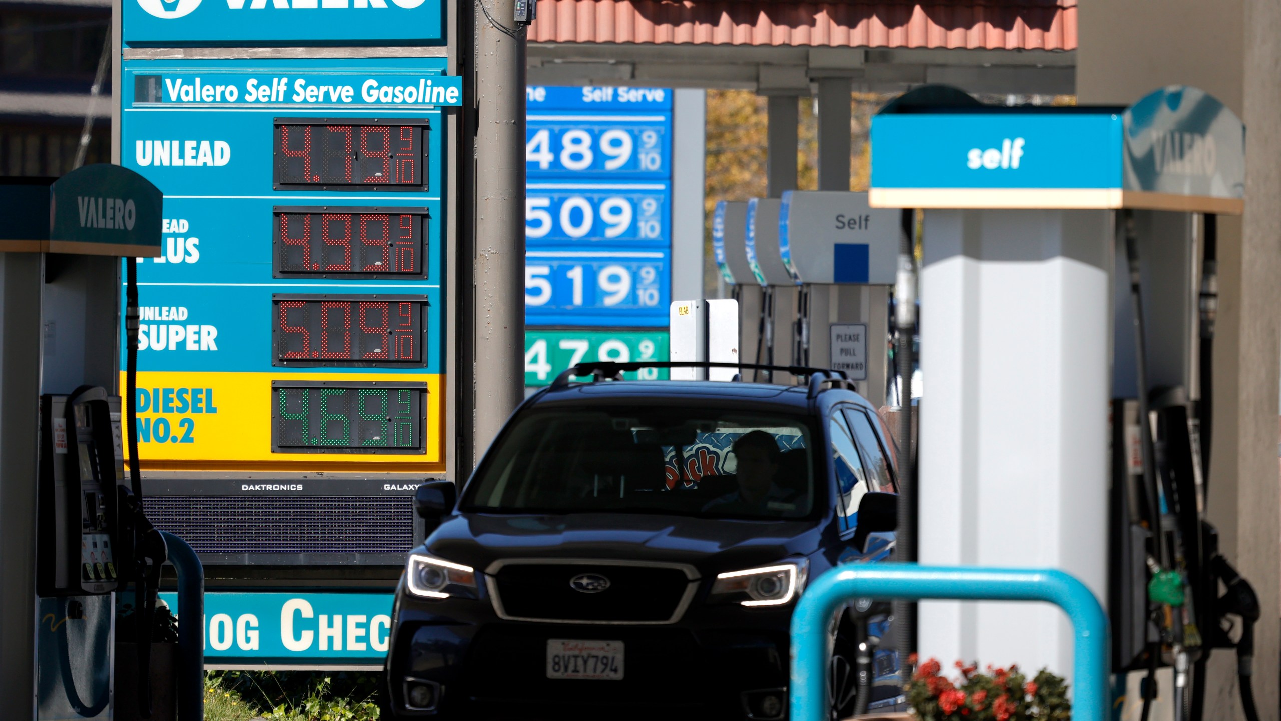 Gas prices nearing $5.00 per gallon are displayed at Valero and Chevron stations on October 12, 2021 in Mill Valley. (Justin Sullivan/Getty Images)