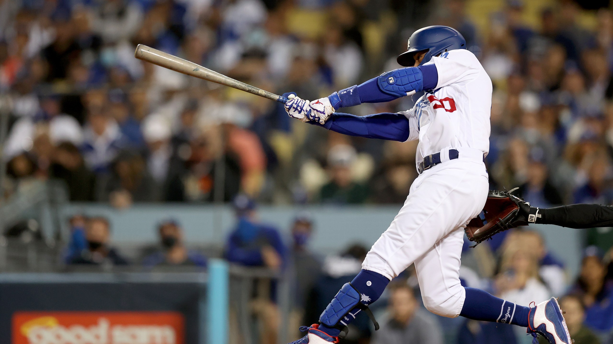 Mookie Betts #50 of the Los Angeles Dodgers watches his single against the San Francisco Giants during the second inning in game 4 of the National League Division Series at Dodger Stadium on Oct. 12, 2021, in Los Angeles, California. (Ronald Martinez/Getty Images)