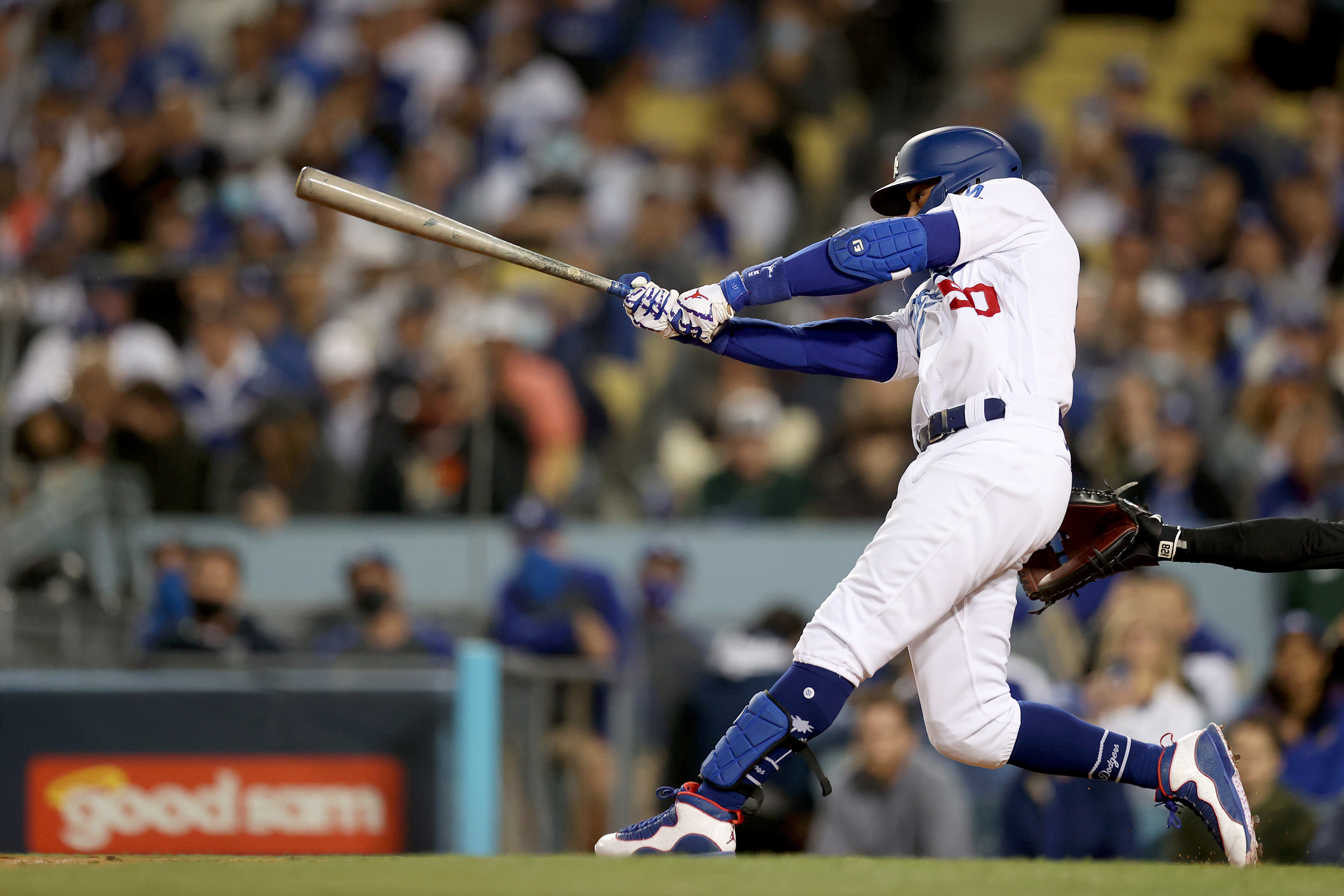 Mookie Betts #50 of the Los Angeles Dodgers watches his single against the San Francisco Giants during the second inning in game 4 of the National League Division Series at Dodger Stadium on Oct. 12, 2021, in Los Angeles, California. (Ronald Martinez/Getty Images)