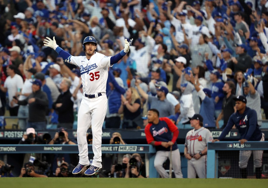 Cody Bellinger of the Los Angeles Dodgers reacts as he rounds the bases after hitting a 3-run home run during the 8th inning of Game 3 of the National League Championship Series against the Atlanta Braves at Dodger Stadium on Oct. 19, 2021. (Sean M. Haffey/Getty Images)