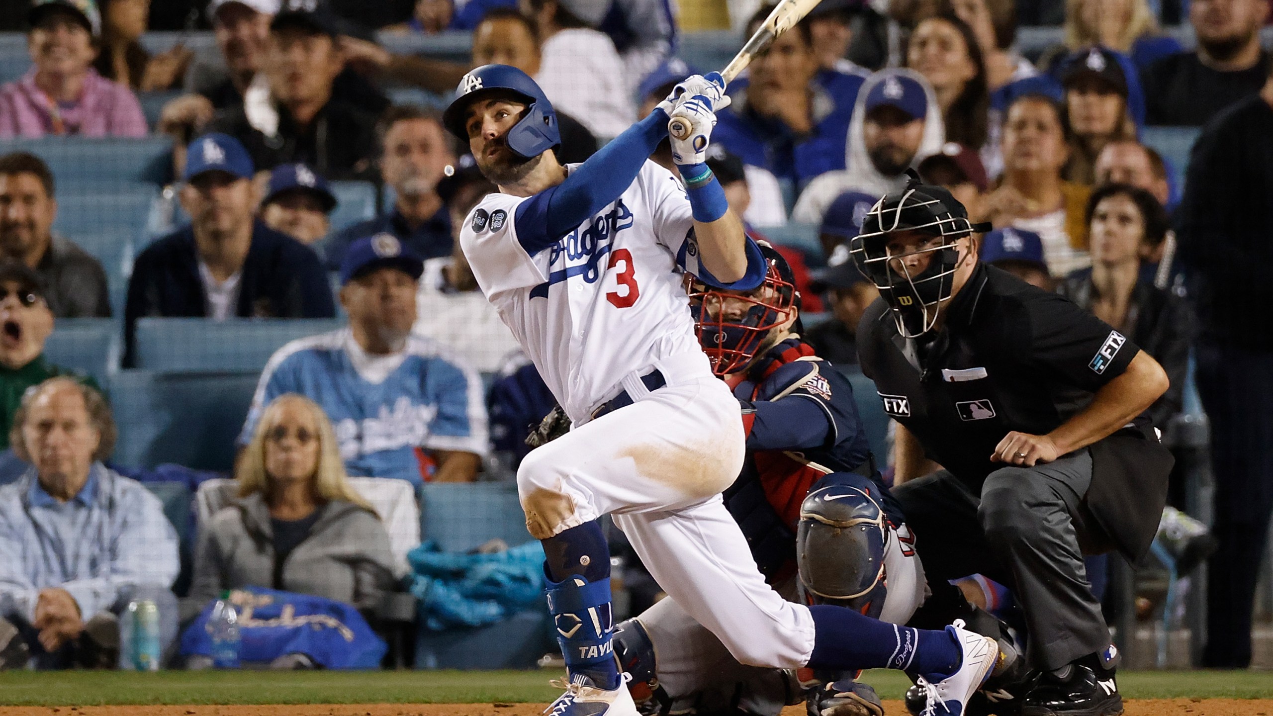 Chris Taylor #3 of the Los Angeles Dodgers hits a solo home run during the seventh inning of Game Five of the National League Championship Series against the Atlanta Braves at Dodger Stadium on Oct. 21, 2021, in Los Angeles, California. (Sean M. Haffey/Getty Images)