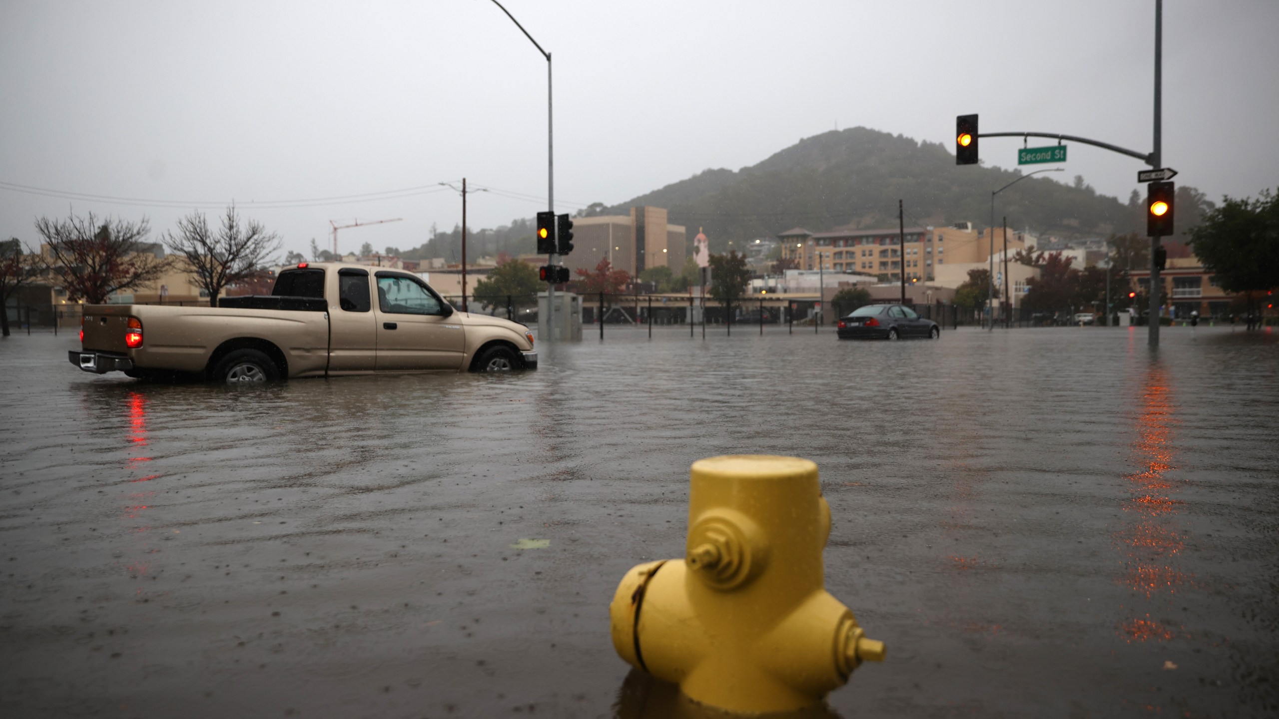 Cars try to navigate a flooded street on Oct. 24, 2021 in San Rafael. (Justin Sullivan/Getty Images)