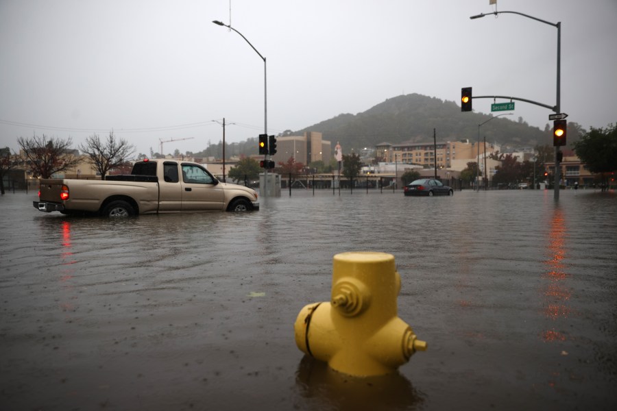 Cars try to navigate a flooded street on Oct. 24, 2021 in San Rafael. (Justin Sullivan/Getty Images)