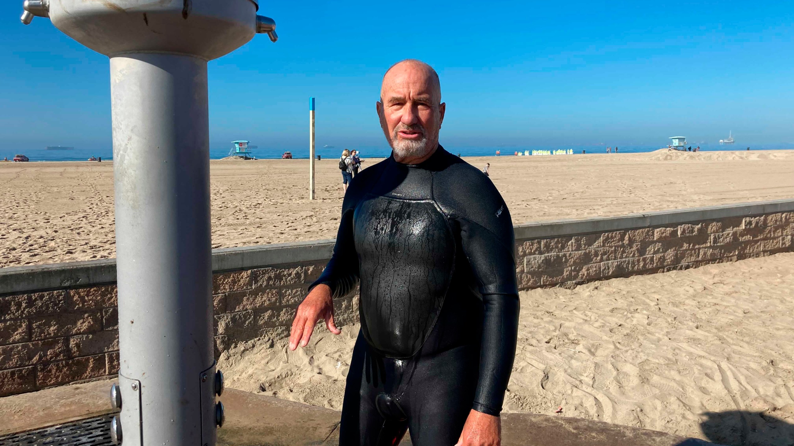 Richard Beach, 69, of Huntington Beach, Calif., said he was told to leave the ocean by lifeguards after he returned to the waves to bodyboard in Huntington Beach, Calif., Sunday, Oct. 10, 2021. The water has been closed to surfing and swimming for a week since an offshore oil pipeline leaked crude into the water off the coast of Orange County. (AP Photo/Amy Taxin)