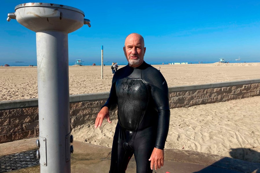 Richard Beach, 69, of Huntington Beach, Calif., said he was told to leave the ocean by lifeguards after he returned to the waves to bodyboard in Huntington Beach, Calif., Sunday, Oct. 10, 2021. The water has been closed to surfing and swimming for a week since an offshore oil pipeline leaked crude into the water off the coast of Orange County. (AP Photo/Amy Taxin)