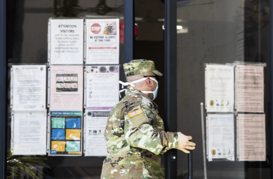 A National Guard sergeant enters a health care facility in 2020 in Hollywood.(Brian van der Brug / Los Angeles Times)