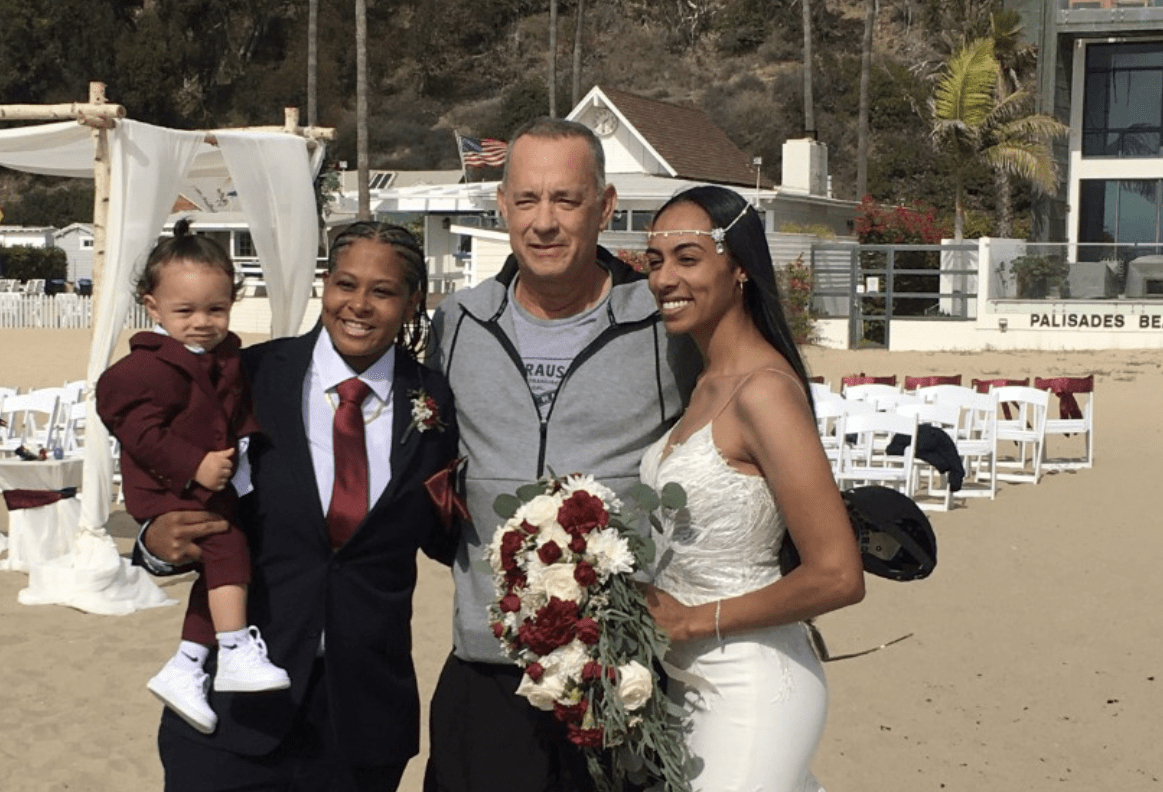 Tom Hanks poses with brides Tashia and Diciembre Farries on their wedding day in Santa Monica in October 2021. (Courtesy of Tashia and Diciembre Farries)