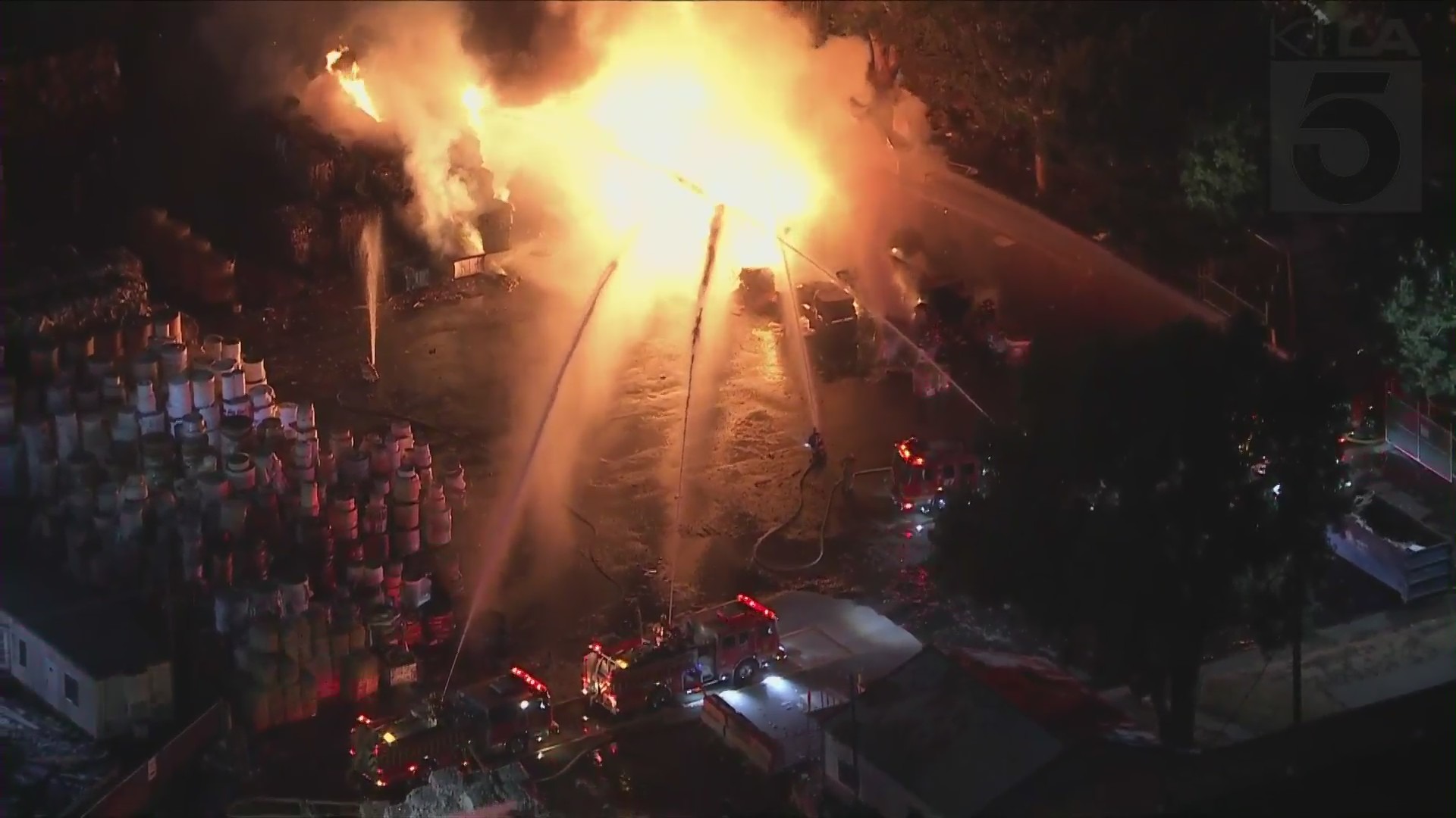 Firefighters work to put out a blaze at a commercial building in Commerce on Oct. 5, 2021. (KTLA)