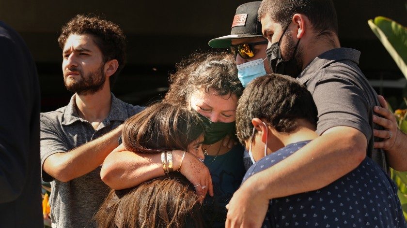 Manuela Sahagun, mother of Mona Rodriguez, center, hugs family members during a news conference outside Long Beach Memorial Care Hospital on Oct. 1, 2021. (Carolyn Cole / Los Angeles Times)