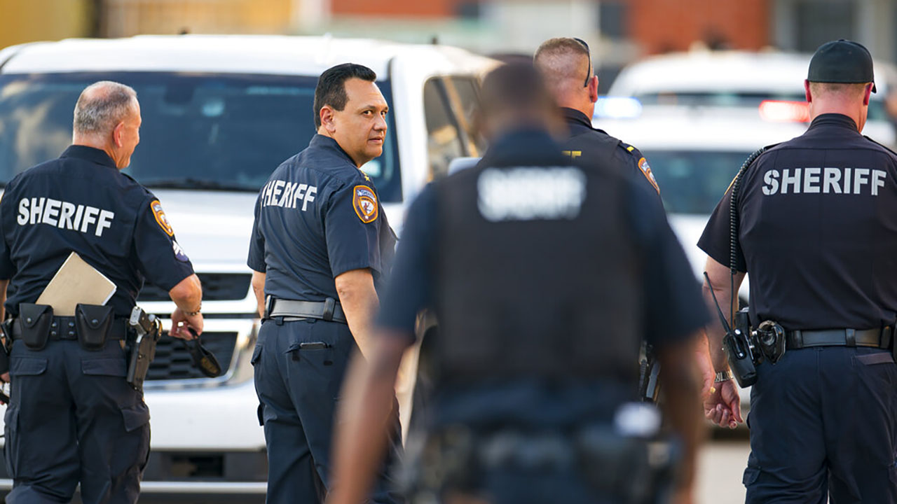 Harris County Sheriff Ed Gonzalez walks back to the scene where, according to Gonzalez, three juveniles were found living alone along with the skeletal remains of another person, possibly a juvenile, in a third floor apartment at the CityParc II at West Oaks Apartments on Sunday, Oct. 24, 2021, at in west Houston. (Mark Mulligan/Houston Chronicle via AP)