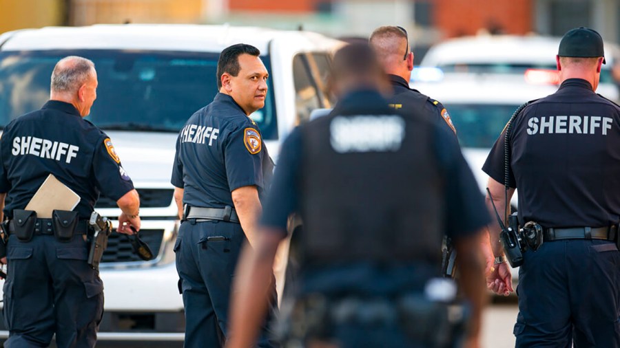 Harris County Sheriff Ed Gonzalez walks back to the scene where, according to Gonzalez, three juveniles were found living alone along with the skeletal remains of another person, possibly a juvenile, in a third floor apartment at the CityParc II at West Oaks Apartments on Sunday, Oct. 24, 2021, at in west Houston. (Mark Mulligan/Houston Chronicle via AP)