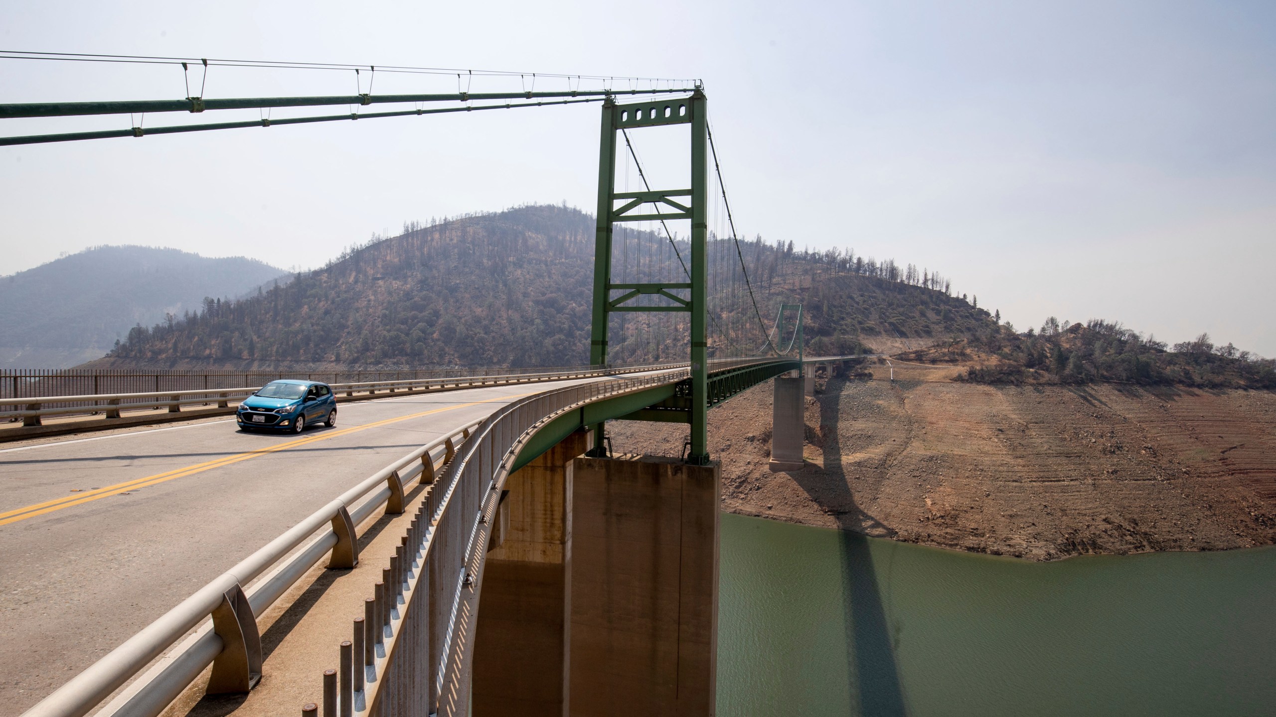 A car passes over the Bidwell Bar Bridge in Lake Oroville in Butte County, Calif., Sunday, Aug. 22, 2021. Oroville voted to become a "constitutional republic" in November of 2021, saying it was fed up with state COVID-19 regulations. (AP Photo/Ethan Swope)