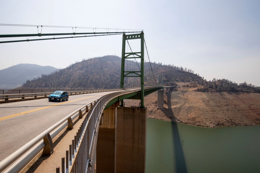 A car passes over the Bidwell Bar Bridge in Lake Oroville in Butte County, Calif., Sunday, Aug. 22, 2021. Oroville voted to become a "constitutional republic" in November of 2021, saying it was fed up with state COVID-19 regulations. (AP Photo/Ethan Swope)