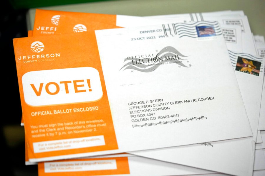 Early ballots wait to be processed by election judges in the Jefferson County, Colo., elections division, Tuesday, Oct. 26, 2021, in Golden, Colo. (AP Photo/David Zalubowski)