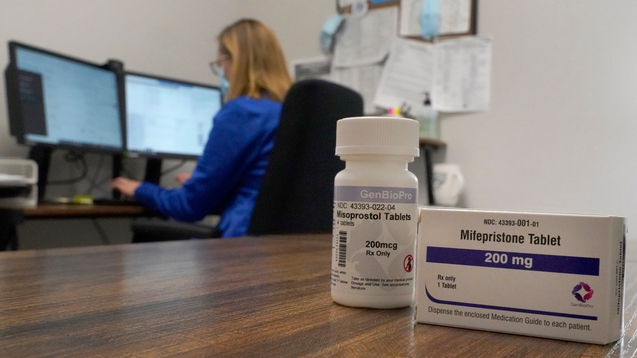 A Nurse Practitioner works in an office at a Planned Parenthood clinic where she confers via teleconference with patients seeking self-managed abortions as containers of the medication used to end an early pregnancy sits on a table nearby Friday, Oct. 29, 2021, in Fairview Heights, Ill. Women with unwanted pregnancies are increasingly considering getting abortion pills by mail. (AP Photo/Jeff Roberson)