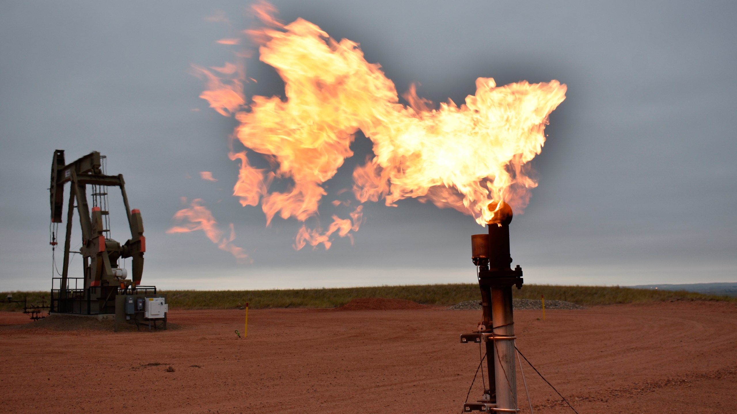 A flare burns natural gas at an oil well on Aug. 26, 2021, in Watford City, N.D. (AP Photo/Matthew Brown, File)