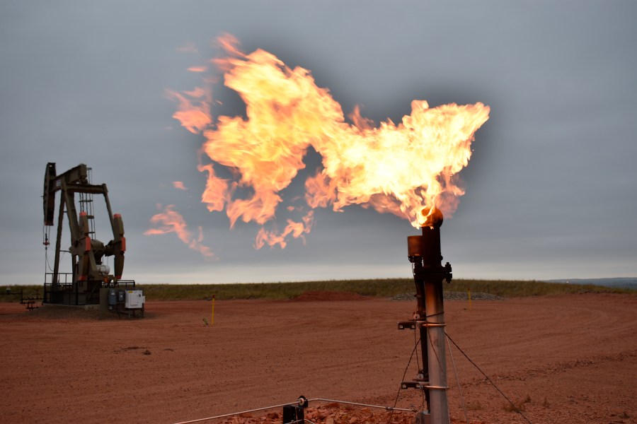 A flare burns natural gas at an oil well on Aug. 26, 2021, in Watford City, N.D. (AP Photo/Matthew Brown, File)