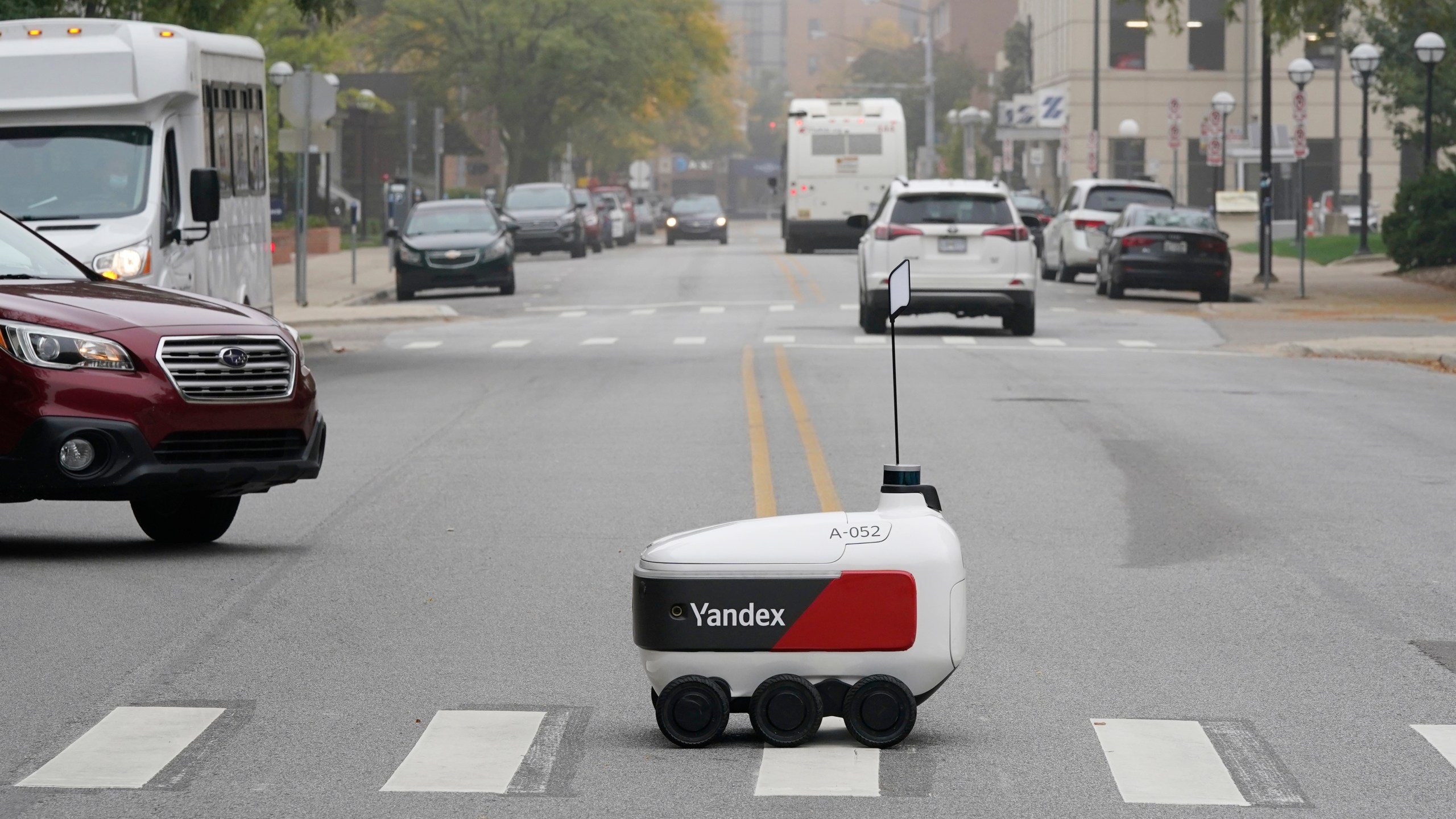 A food delivery robot crosses a street in Ann Arbor, Mich. on Thursday, Oct. 7, 2021. (AP Photo/Carlos Osorio)