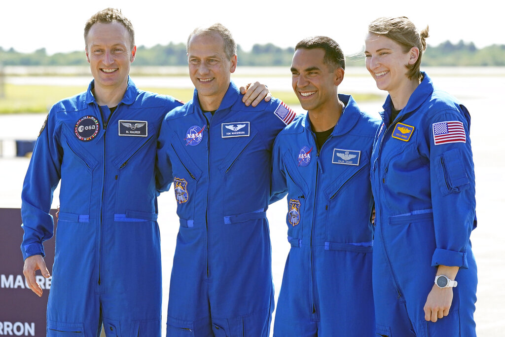 From left, European Space Agency astronaut Matthias Maurer of Germany, and NASA astronauts Tom Marshburn, Raja Chari, and Kayla Barron gather for a photo after arriving at the Kennedy Space Center in Cape Canaveral, Fla., on Tuesday, Oct. 26, 2021. (AP Photo/John Raoux)