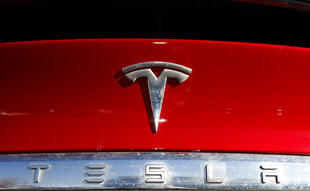 The Tesla company logo sits on an unsold 2020 Model X at a Tesla dealership in Littleton, Colo., on Feb. 2, 2020. (AP Photo/David Zalubowski, File)