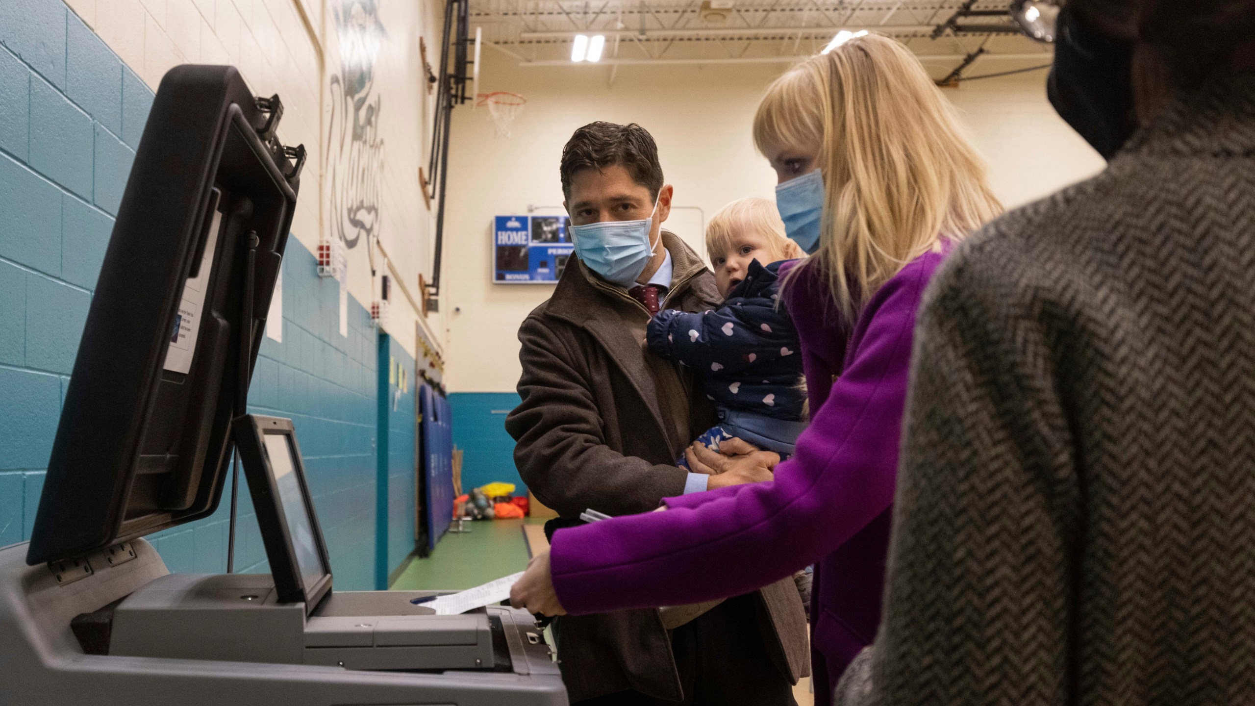 Mayor Jacob Frey casts his vote on Election Day alongside his family at the Marcy Arts Magnet Elementary School on Tuesday, Nov. 2, 2021 in Minneapolis. Voters in Minneapolis are deciding whether to replace the city’s police department with a new Department of Public Safety. The election comes more than a year after George Floyd’s death launched a movement to defund or abolish police across the country. (AP Photo/Christian Monterrosa)