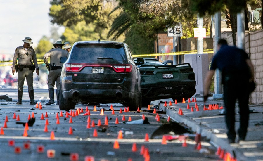 Las Vegas Metro Police investigators work at the scene of a fatal crash on South Rainbow Boulevard between Tropicana Avenue and Flamingo Road in Las Vegas on Nov. 2, 2021. Raiders wide receiver Henry Ruggs III is facing a driving under the influence charge after the fiery vehicle crash. (Steve Marcus/Las Vegas Sun via Associated Press)