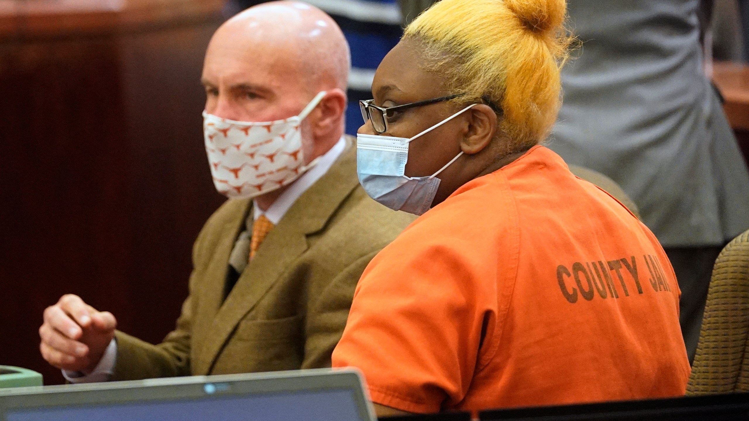 Defense attorney Neal Davis III sits with his client Gloria Williams during a bail review hearing, Friday, Nov. 5, 2021 in Houston. Gloria Williams charged in connection with the death of her 8-year-old son, whose skeletal remains decomposed for months inside a Houston-area apartment with three surviving but abandoned siblings, continued to receive government assistance on behalf of her son even after he was allegedly beaten to death by her boyfriend, a prosecutor said Friday. (Melissa Phillip/Houston Chronicle via AP)