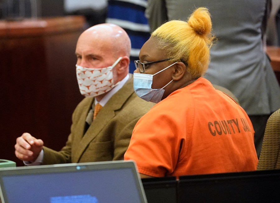 Defense attorney Neal Davis III sits with his client Gloria Williams during a bail review hearing, Friday, Nov. 5, 2021 in Houston. Gloria Williams charged in connection with the death of her 8-year-old son, whose skeletal remains decomposed for months inside a Houston-area apartment with three surviving but abandoned siblings, continued to receive government assistance on behalf of her son even after he was allegedly beaten to death by her boyfriend, a prosecutor said Friday. (Melissa Phillip/Houston Chronicle via AP)