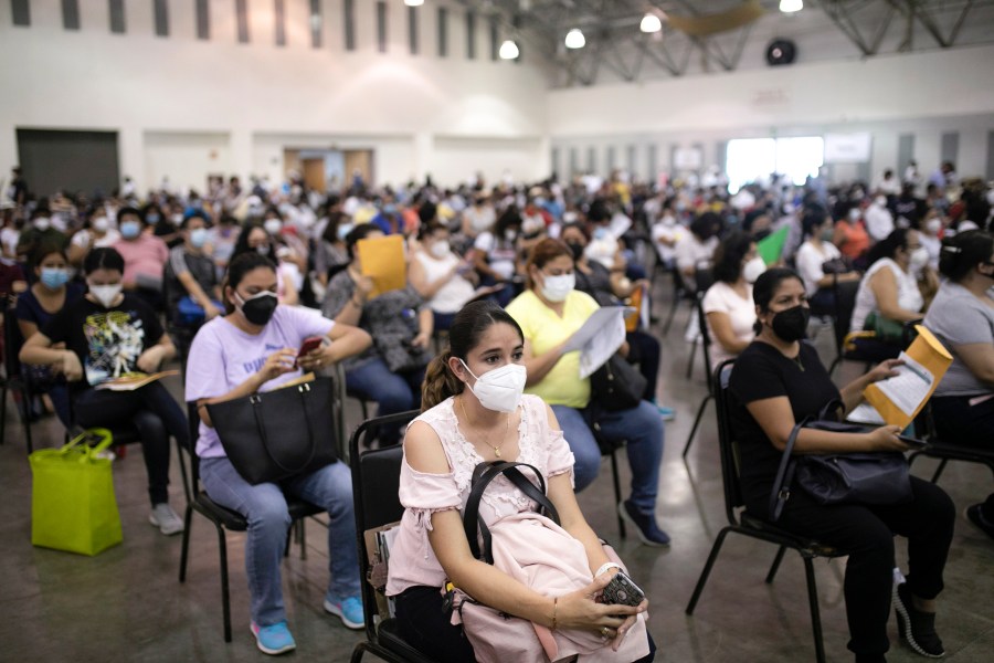 Education workers wait for their jab of the single-dose CanSino COVID-19 vaccine during a vaccination drive at the World Trade Center in Boca del Rio, Veracruz state, Mexico, April 20, 2021. (AP Photo/Felix Marquez, File)