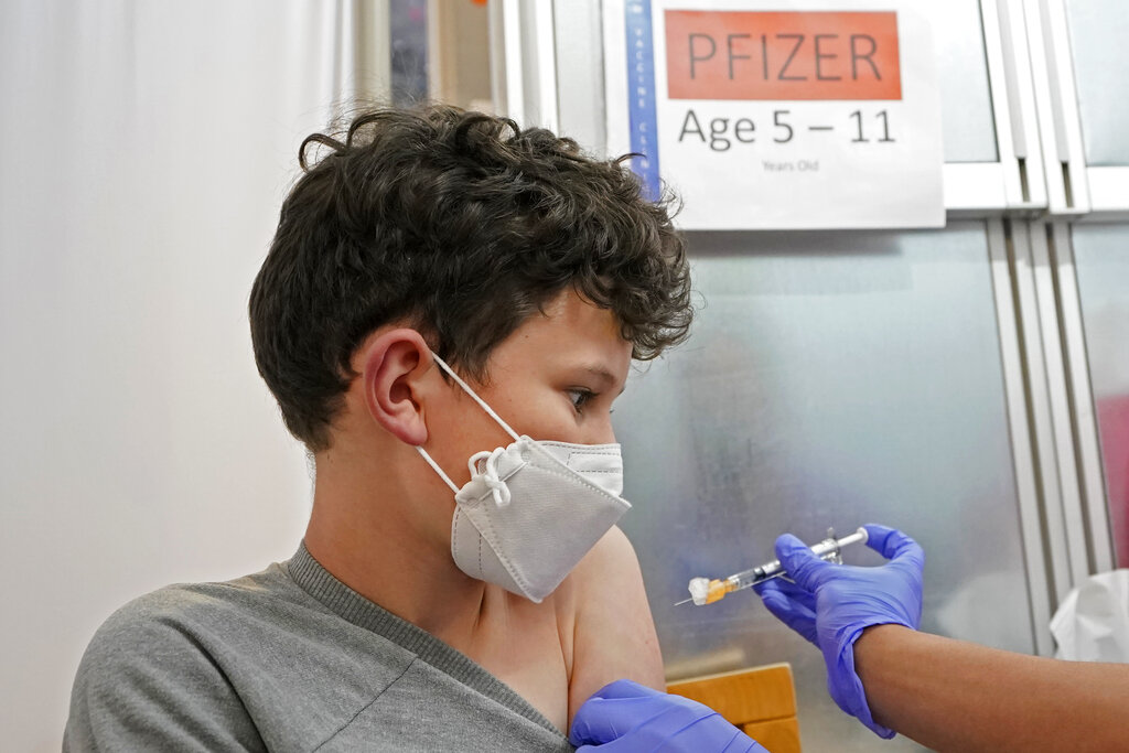 Leo Hahn, 11, gets the first shot of the Pfizer COVID-19 vaccine, Tuesday, Nov. 9, 2021, at the University of Washington Medical Center in Seattle. (AP Photo/Ted S. Warren)