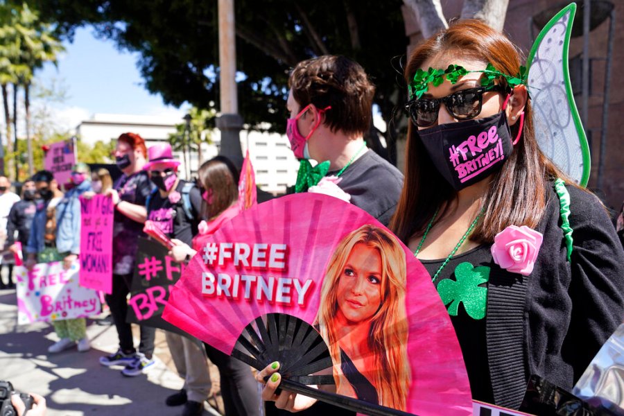 Britney Spears supporter Kiki Norberto holds a hand fan outside a court hearing concerning the pop singer's conservatorship at the Stanley Mosk Courthouse on March 17, 2021, in Los Angeles. (AP Photo/Chris Pizzello, File)