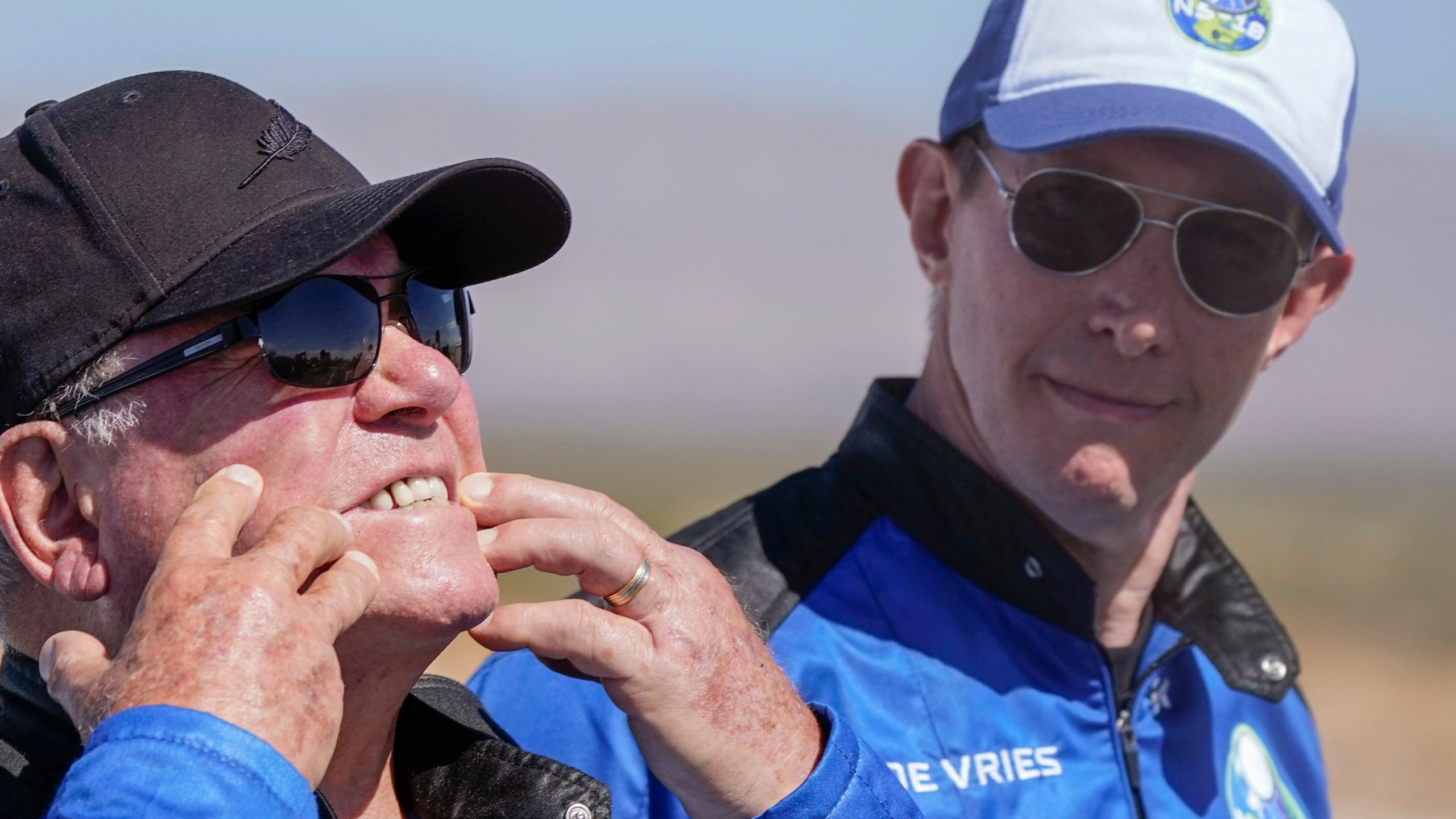 Glen de Vries, right, takes a look as William Shatner, left, shows what rocket lift off did to his face during a media availability at the spaceport near Van Horn, Texas, Wednesday, Oct. 13, 2021. Glen de Vries, 49, and Thomas P. Fischer, 54, died in crash of a single-engine Cessna 172 that went down Thursday, Nov. 11, in a wooded area of Hampton Township, N.J. (AP Photo/LM Otero, File)