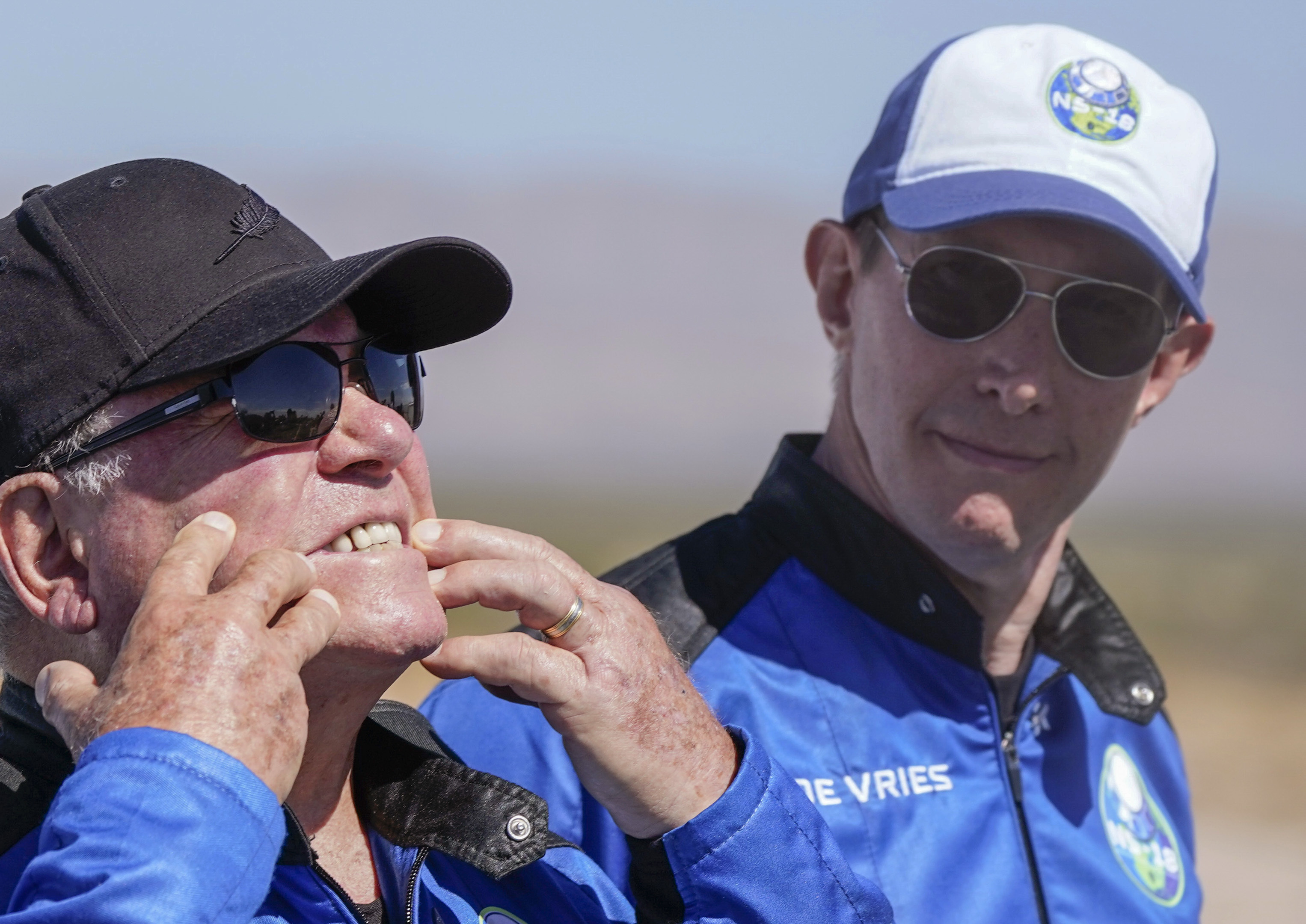 Glen de Vries, right, takes a look as William Shatner, left, shows what rocket lift off did to his face during a media availability at the spaceport near Van Horn, Texas, Wednesday, Oct. 13, 2021. Glen de Vries, 49, and Thomas P. Fischer, 54, died in crash of a single-engine Cessna 172 that went down Thursday, Nov. 11, in a wooded area of Hampton Township, N.J. (AP Photo/LM Otero, File)