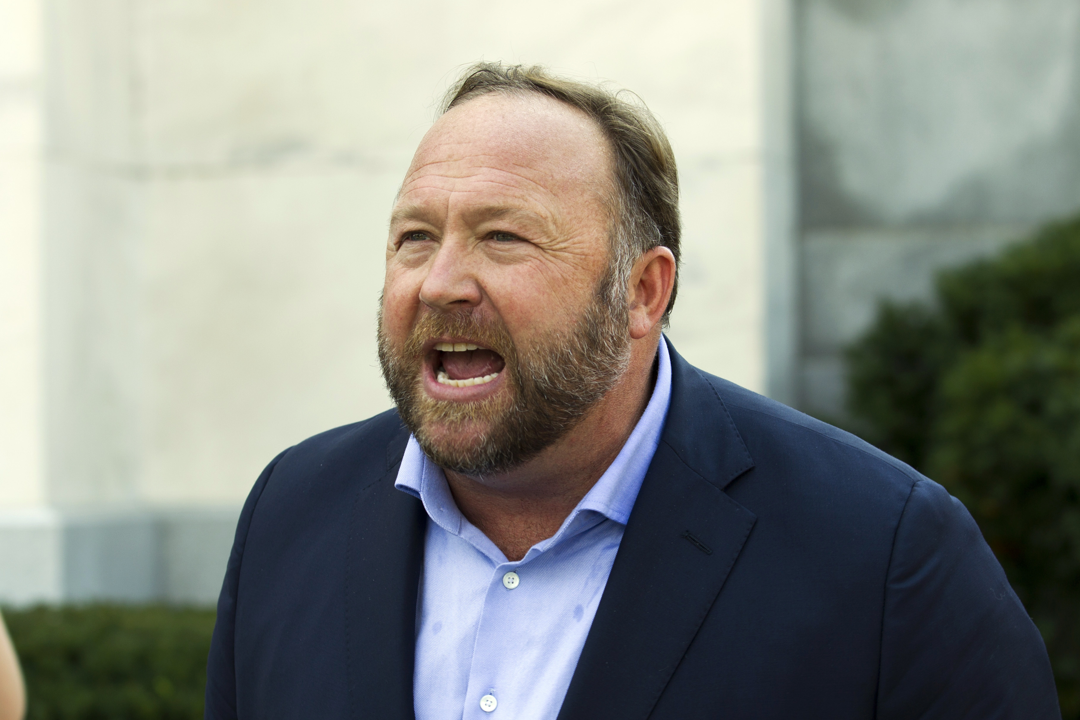 In this Sept. 5, 2018, file photo, Infowars host and conspiracy theorist Alex Jones speaks outside of the Dirksen building on Capitol Hill in Washington. (Jose Luis Magana/Associated Press)