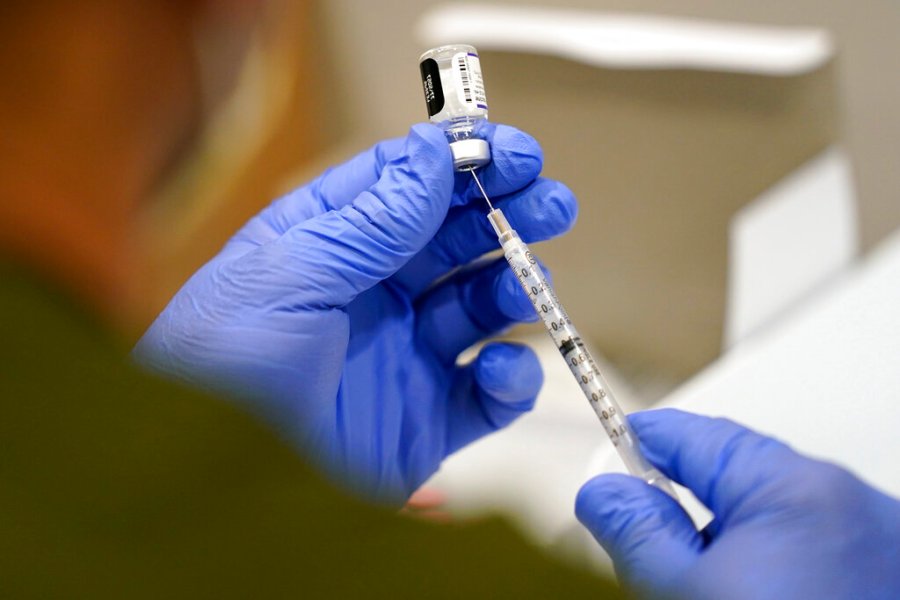 A healthcare worker fills a syringe with the Pfizer COVID-19 vaccine at Jackson Memorial Hospital on Oct. 5, 2021, in Miami. (AP Photo/Lynne Sladky, File)