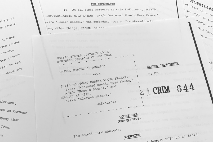 The grand jury indictment against Iranian nationals Seyyed Mohammad Hosein Musa Kazemi and Sajjad Kashian is photographed Thursday, Nov. 18, 2021. The two suspected Iranian computer hackers have been charged with election interference, accused of trying to intimidate American voters ahead of last year's U.S. presidential election by sending threatening messages and spreading disinformation. (AP Photo/Jon Elswick)