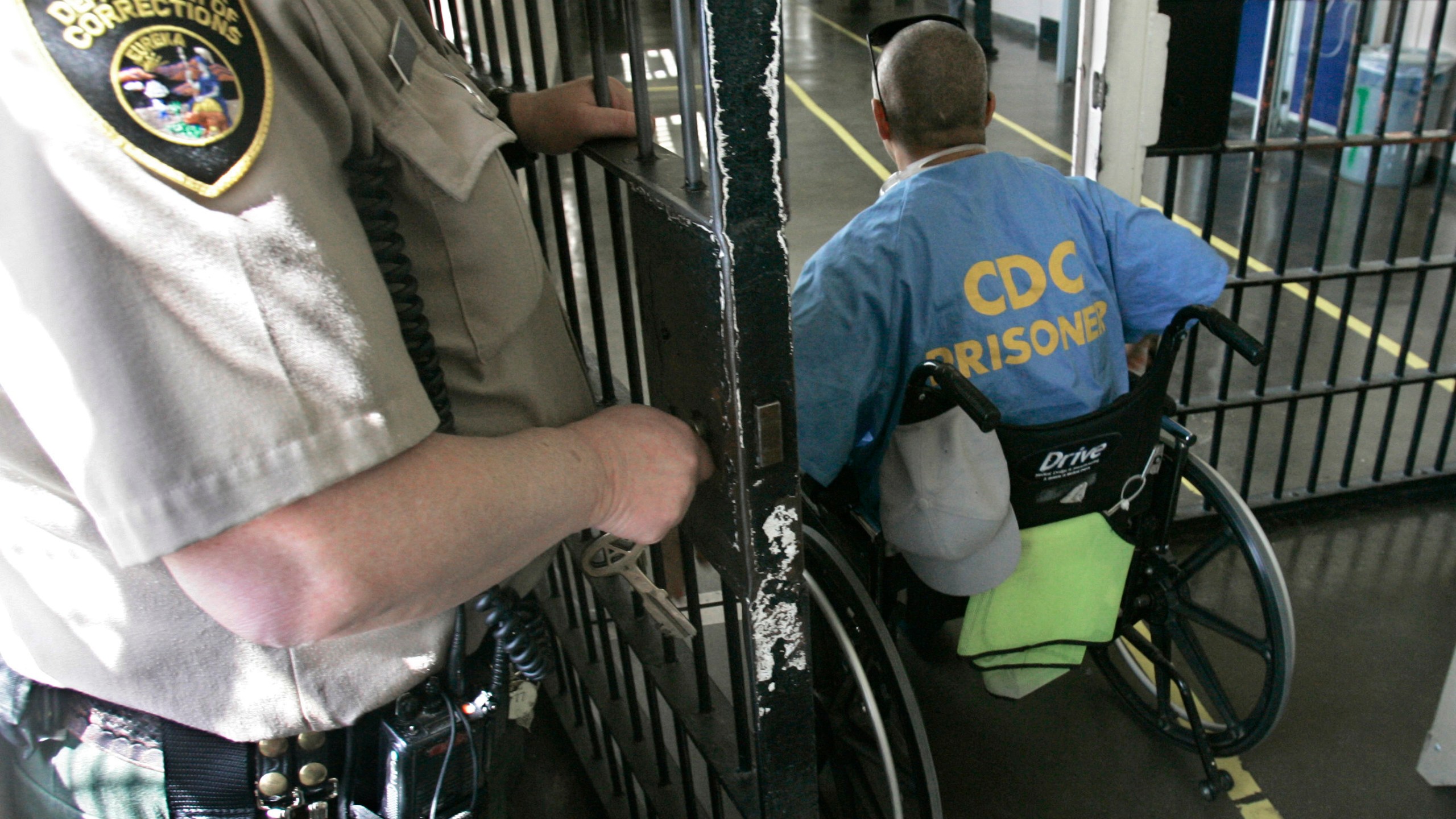 A wheelchair-bound inmate wheels himself through a checkpoint at the California Medical Facility in Vacaville on April 9, 2008. California corrections officials have begun limiting medical parole only to inmates so ill they are on ventilators. (Rich Pedroncelli/Associated Press)