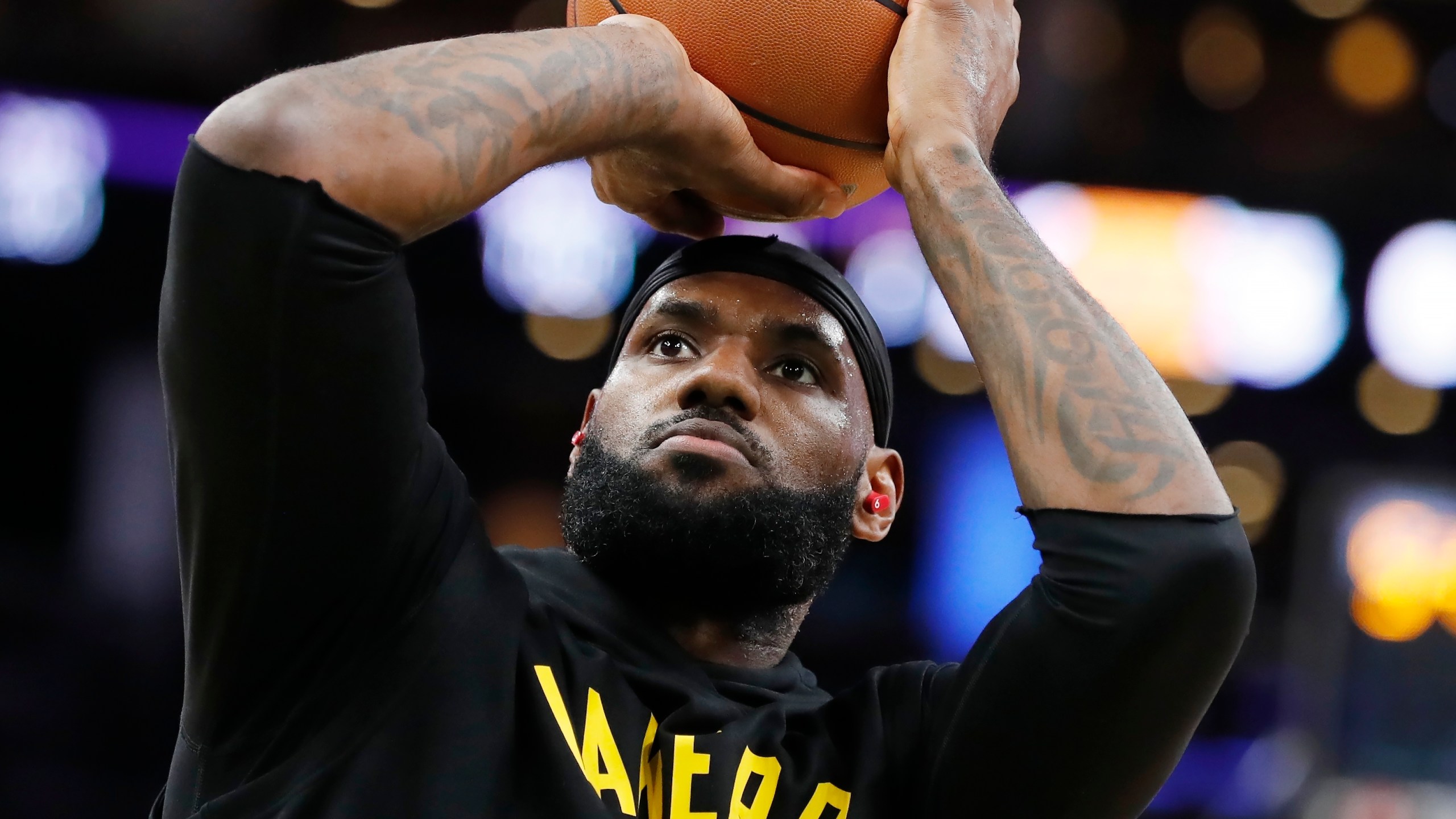 Los Angeles Lakers' LeBron James warms up before an NBA basketball game against the Boston Celtics on Nov. 19, 2021, in Boston. (AP Photo/Michael Dwyer)