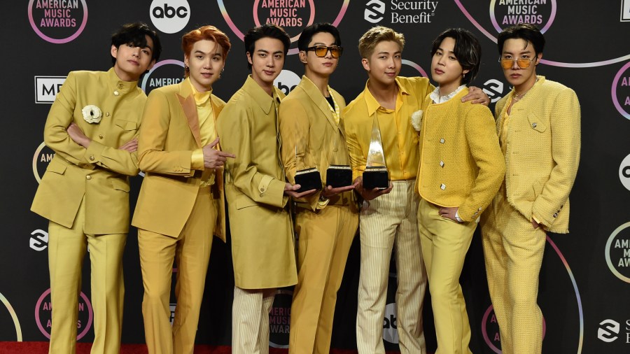 BTS poses in the press room with the awards for favorite pop duo or group, favorite pop song for “Butter,” and artist of the year at the American Music Awards on Sunday, Nov. 21, 2021, at Microsoft Theater in Los Angeles. (Jordan Strauss/Invision/AP)