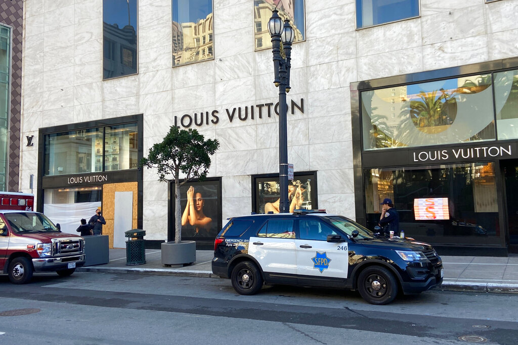 Police officers and emergency crews park outside the Louis Vuitton store in San Francisco's Union Square on Nov. 21, 2021, after looters ransacked businesses. (Danielle Echeverria/San Francisco Chronicle via AP, File)