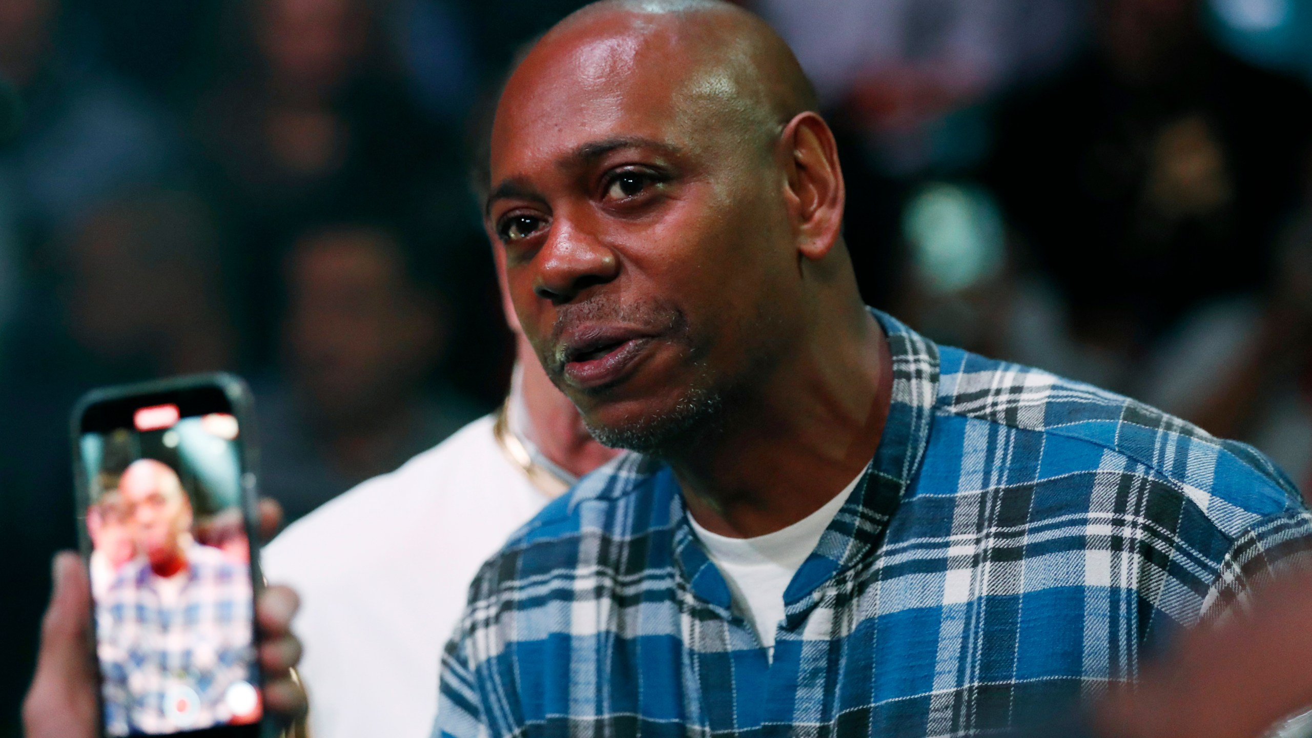 Comedian Dave Chappelle attends a boxing bout Nov. 6, 2021, in Las Vegas. Two former Netflix employees who raised concerns about anti-transgender comments on Dave Chappelle’s TV special are dropping labor complaints and one has resigned from the company. Terra Field, a senior software engineer who is trans, announced a voluntary resignation on Monday, Nov. 22. Field and B. Pagels-Minor also are dropping a National Labor Relations Board complaint that claimed retaliation. (AP Photo/Steve Marcus, File)